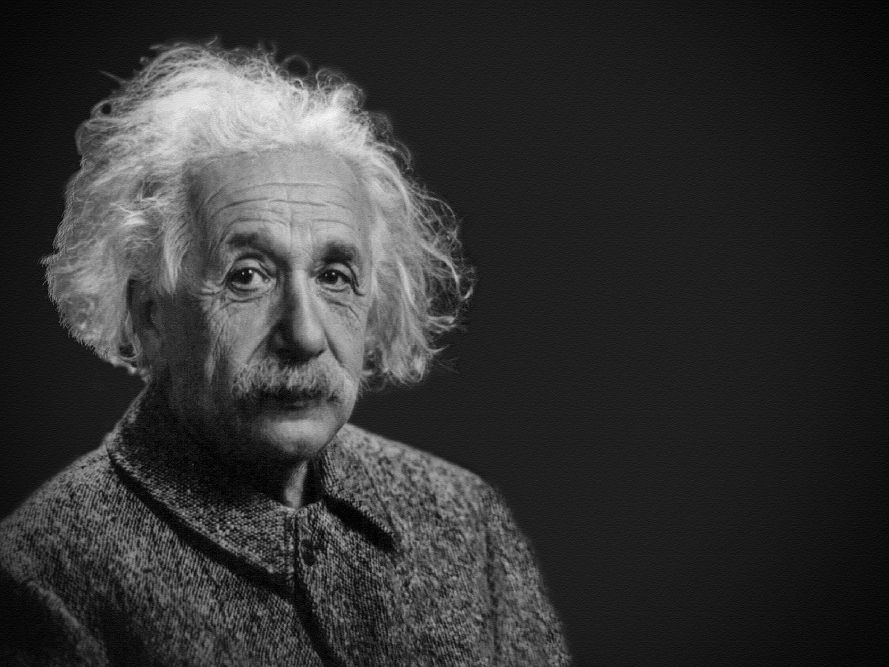 Portret Alberta Einsteina na czarnym tle